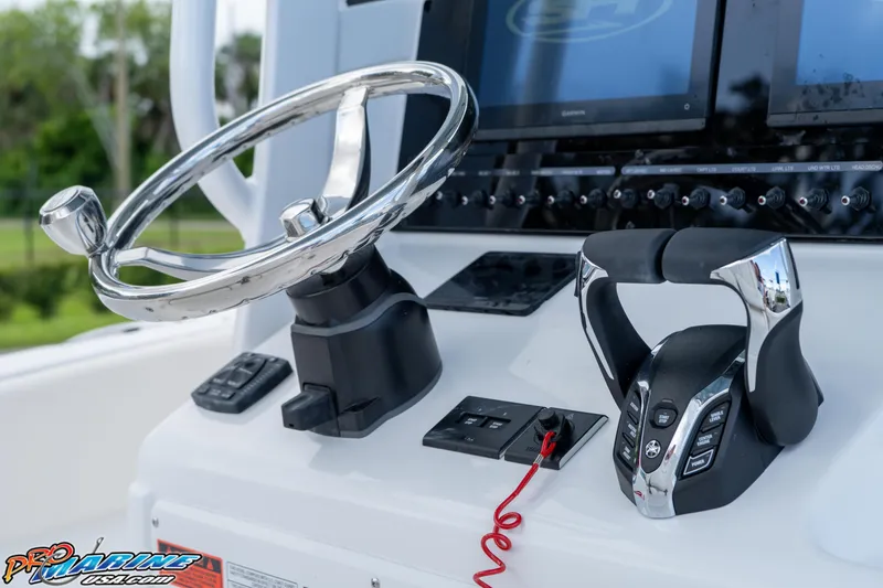 Slide: The Image of 2026 Sea Hunt Ultra 265 SE boat helm with steering wheel and controls. - 14