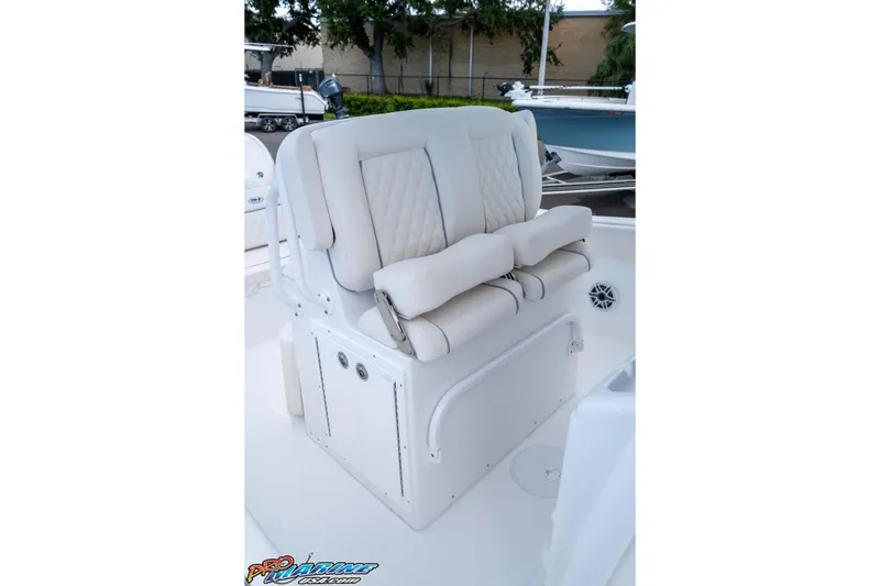 Slide: The Image of 2026 Sea Hunt Ultra 265 SE boat seating with white cushioned upholstery. - 18