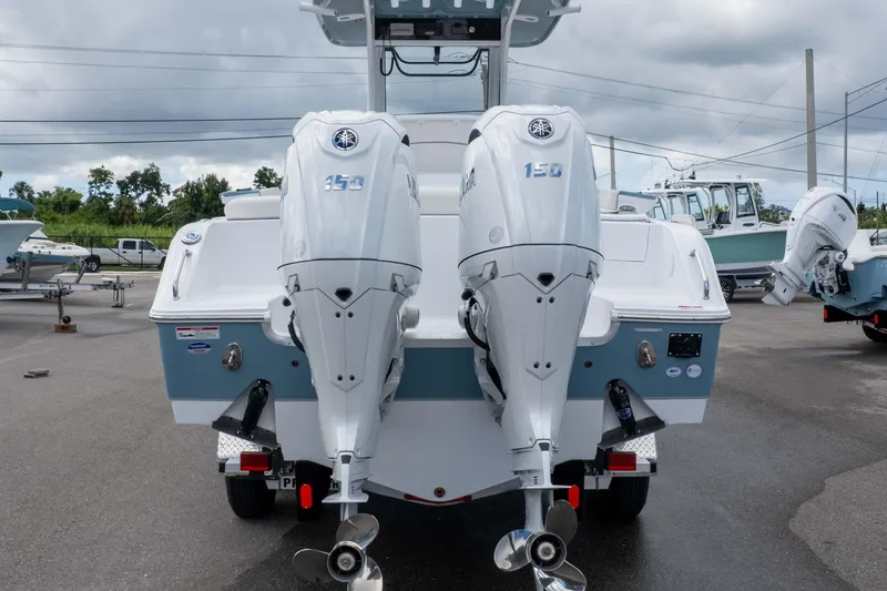 Slide: The Image of 2026 Sea Hunt Ultra 265 SE boat with dual 150 horsepower engines, parked on a trailer. - 19