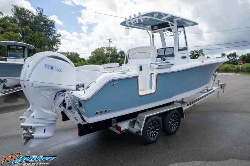 Slide: The Image of 2026 Sea Hunt Ultra 265 SE boat on trailer, featuring Yamaha outboard motor. - 23