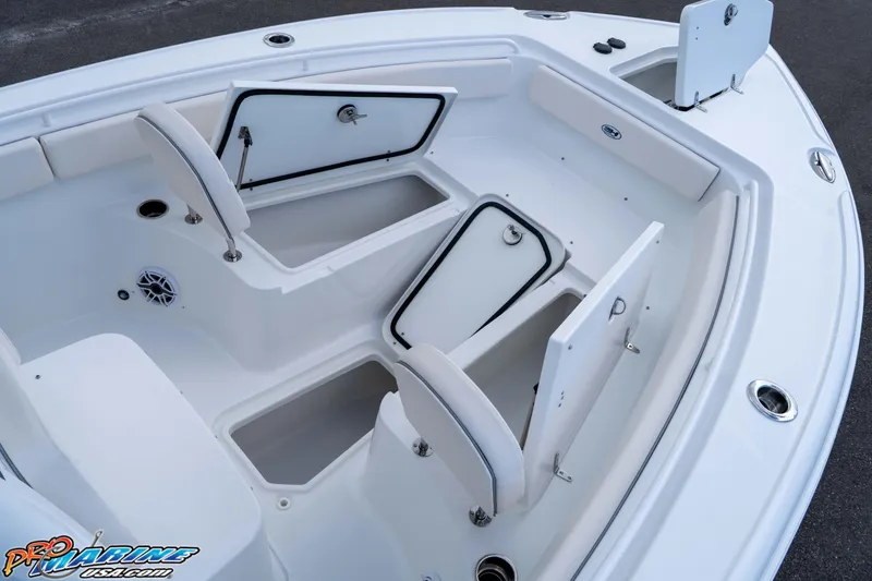 Slide: The Image of 2026 Sea Hunt Ultra 265 SE boat with open storage compartments and seating. - 24