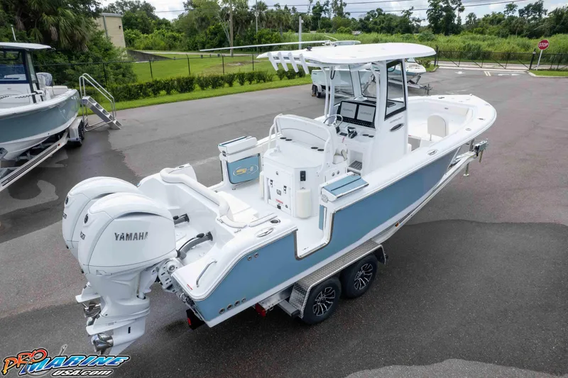 Slide: The Image of 2026 Sea Hunt Ultra 265 SE boat with Yamaha engines on a trailer. - 25