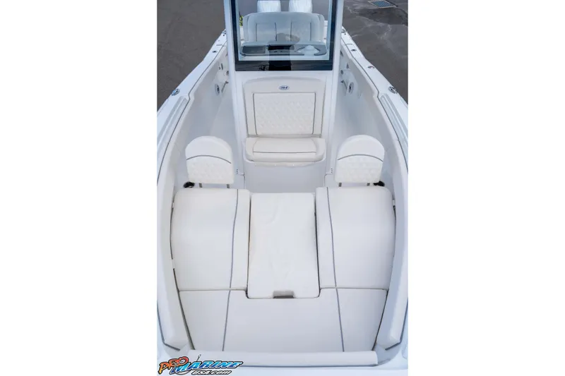 Slide: The Image of 2026 Sea Hunt Ultra 265 SE boat interior with white cushioned seating. - 28