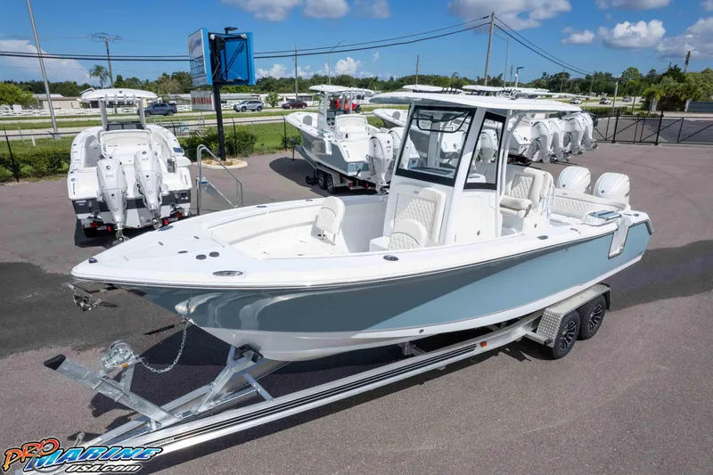 Slide: The Image of 2026 Sea Hunt Ultra 265 SE boat on trailer, displayed outdoors under blue sky. - 3