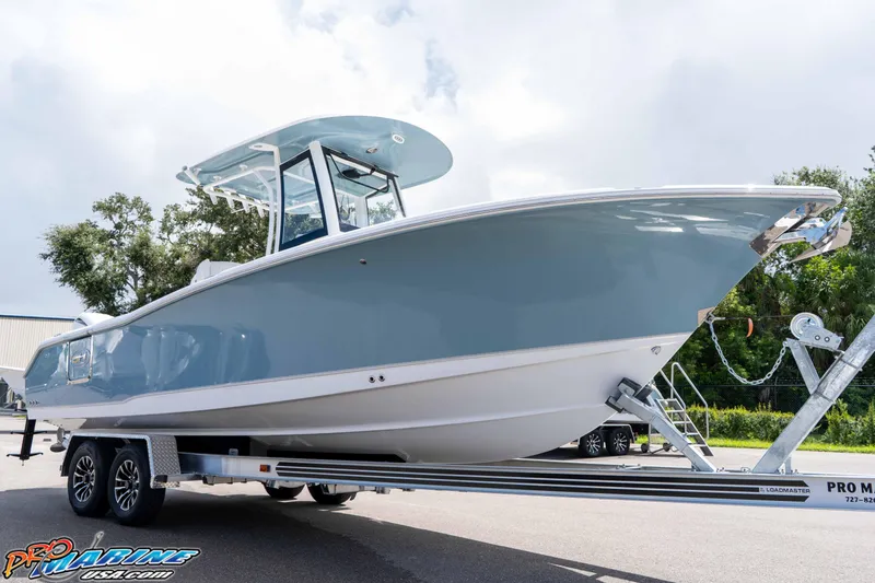 Slide: The Image of 2026 Sea Hunt Ultra 265 SE boat on trailer, displayed outdoors. - 36