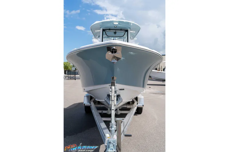Slide: The Image of 2026 Sea Hunt Ultra 265 SE boat on trailer, front view under clear sky. - 38