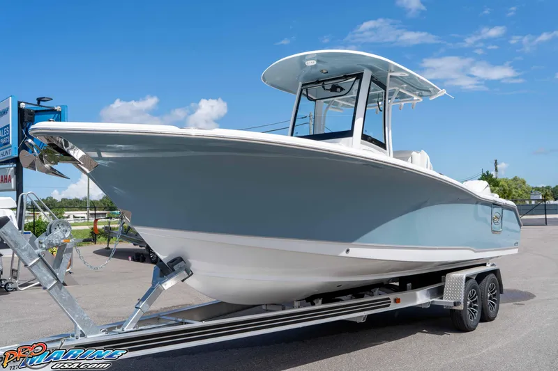 Slide: The Image of 2026 Sea Hunt Ultra 265 SE boat on trailer under clear blue sky. - 39