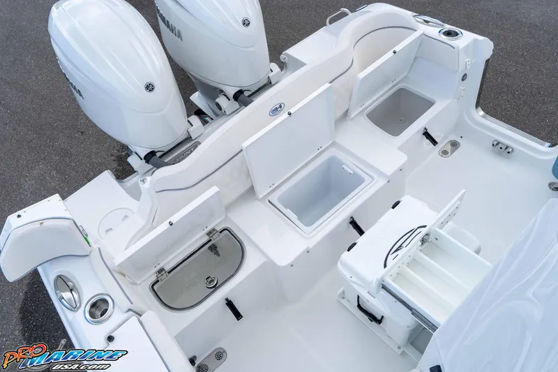 Slide: The Image of 2026 Sea Hunt Ultra 265 SE boat deck with storage compartments and dual Yamaha engines. - 4