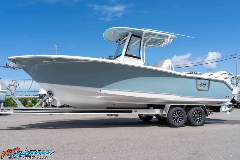 Slide: The Image of 2026 Sea Hunt Ultra 265 SE boat on trailer, clear sky background. - 40