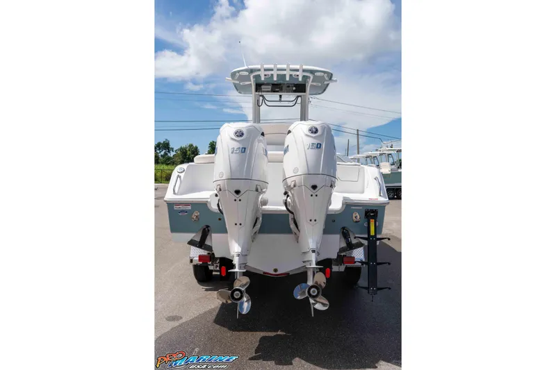 Slide: The Image of 2026 Sea Hunt Ultra 265 SE boat with dual outboard engines, parked outdoors. - 44