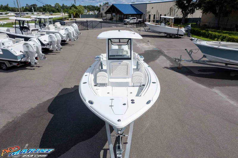 Slide: The Image of 2026 Sea Hunt Ultra 265 SE boat displayed at a dealership, surrounded by other boats. - 7
