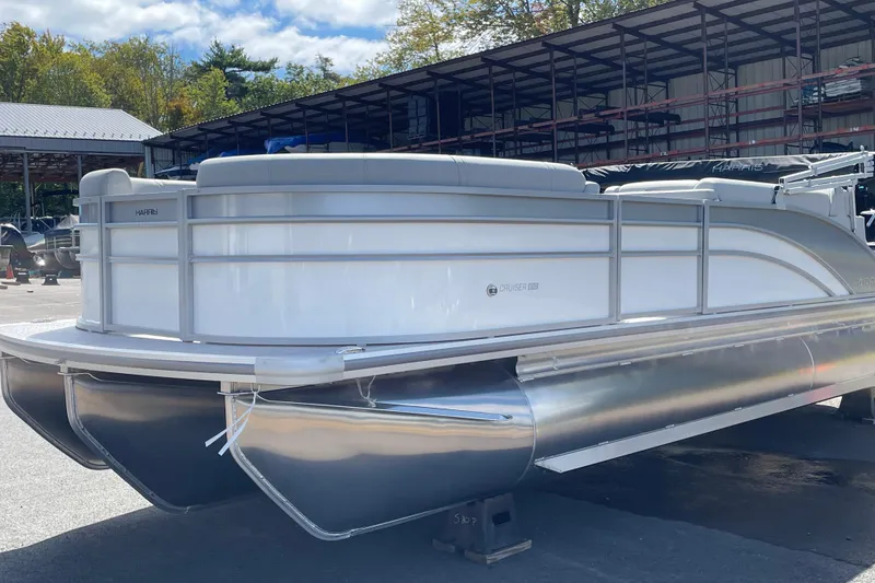 Slide: The Image of 2026 Harris FloteBote Cruiser 210 pontoon boat in a marina setting. - 2