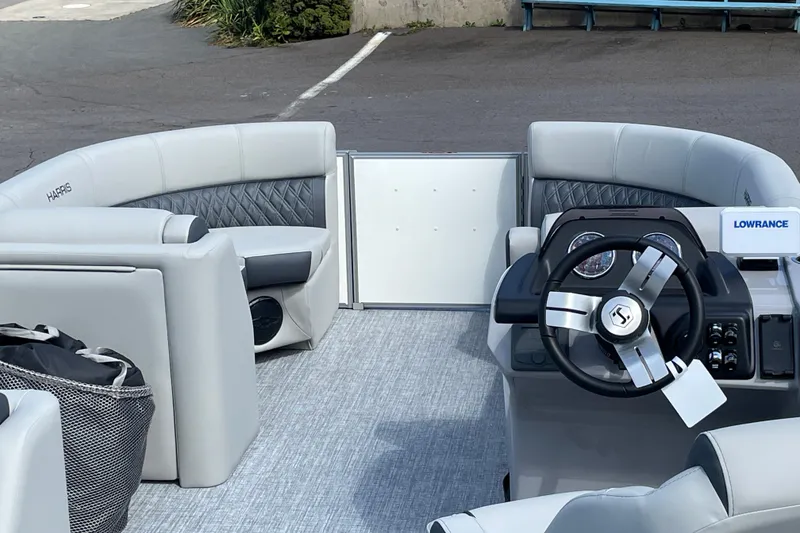 Slide: The Image of 2026 Harris FloteBote Cruiser 210 interior with modern steering and seating. - 5