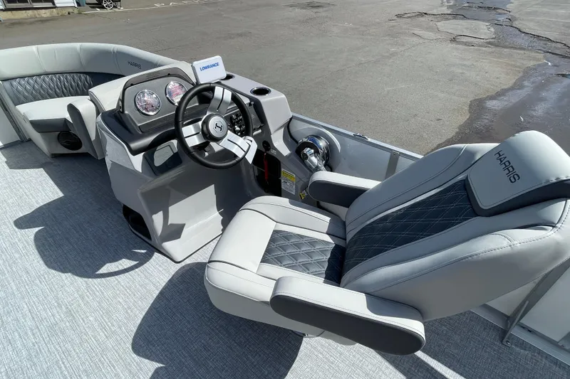 Slide: The Image of 2026 Harris FloteBote Cruiser 210 interior with modern steering and luxurious seating. - 7