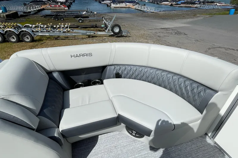 Slide: The Image of Luxurious seating on 2026 Harris FloteBote Cruiser 210 pontoon boat, dockside view. - 9