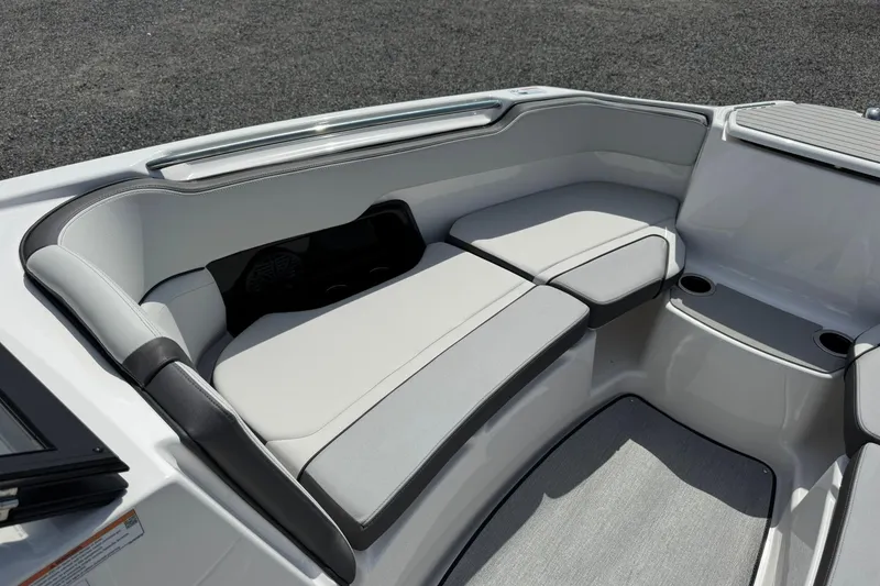 Slide: The Image of 2026 Yamaha Boats AR250 interior seating with sleek, modern design and cup holders. - 13