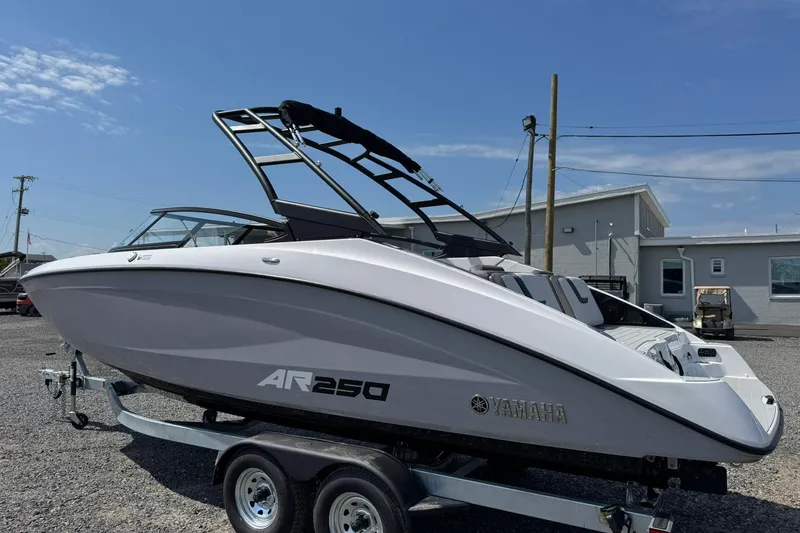 Slide: The Image of 2026 Yamaha Boats AR250 on trailer, sleek design under clear blue sky. - 3