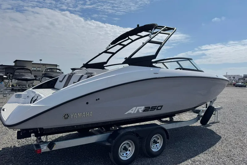 Slide: The Image of 2026 Yamaha Boats AR250 on trailer under clear sky. - 4