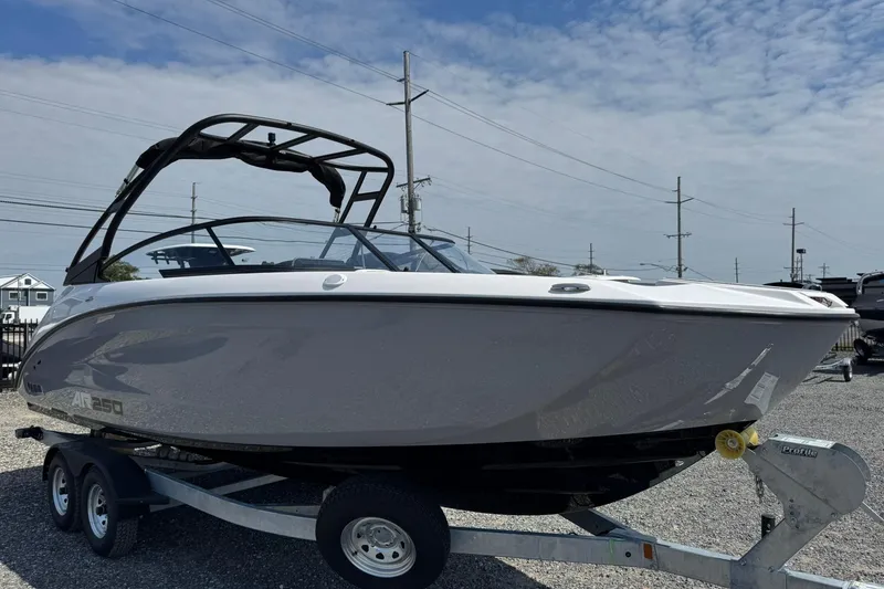 Slide: The Image of 2026 Yamaha Boats AR250 on trailer, sleek design under a clear sky. - 5