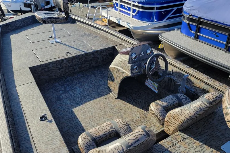 Slide: The Image of 2026 Xpress XP200 Catfish boat interior with camouflage seating and steering console. - 3