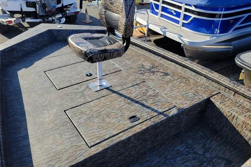 Slide: The Image of 2026 Xpress XP200 Catfish boat interior with camo seat and storage compartments. - 4