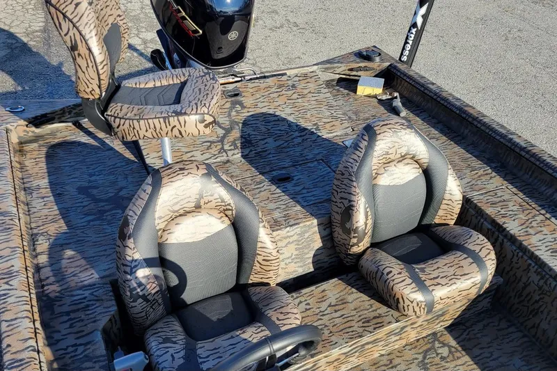 Slide: The Image of 2026 Xpress XP200 Catfish boat interior with camo seats and motor. - 6