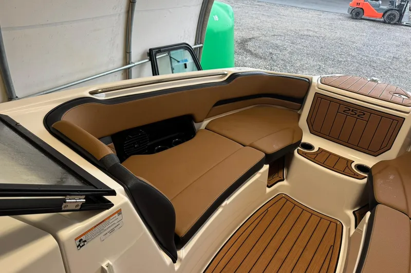Slide: The Image of 2026 Yamaha Boats 252SD interior with tan seating and wood accents. - 12