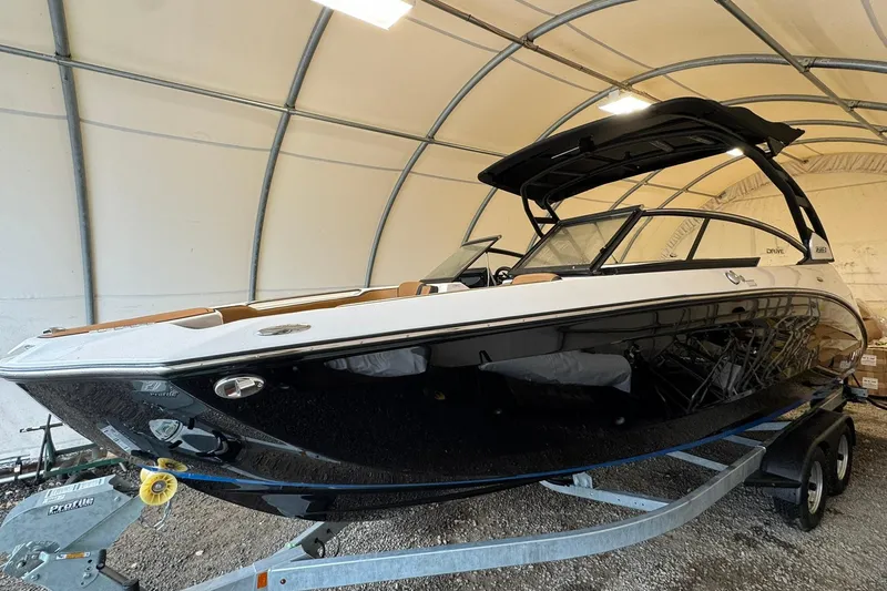 Slide: The Image of 2026 Yamaha Boats 252SD in a covered storage area, sleek design on trailer. - 3
