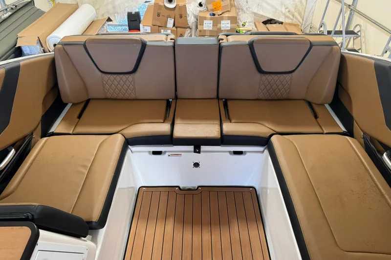 Slide: The Image of 2026 Yamaha Boats 252SD interior with tan seating and wood-style flooring. - 6