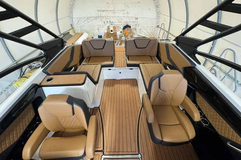 Slide: The Image of Luxurious interior of 2026 Yamaha Boats 252SD with tan leather seating and wood flooring. - 8