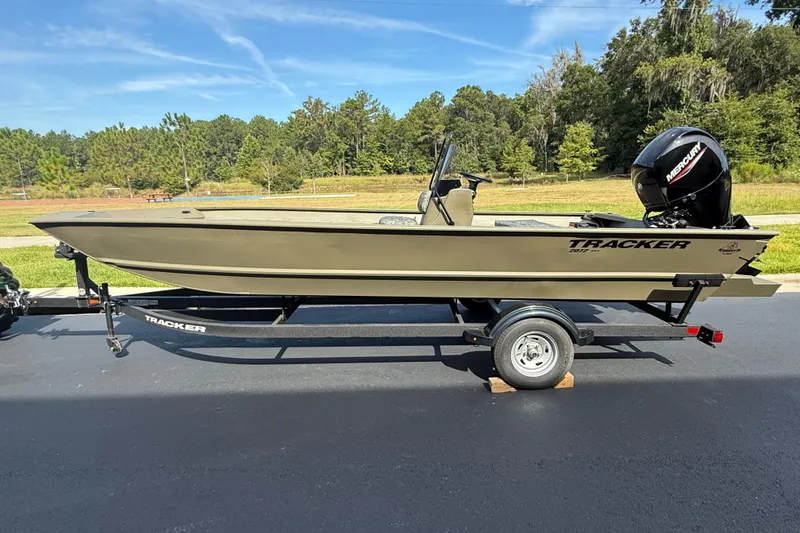 The Image of 2026 Tracker Grizzly 2072 CC boat on trailer, outdoors, with Mercury engine. - 0