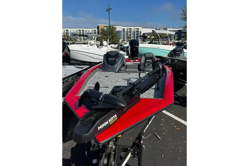 Slide: The Image of 2026 Tracker Pro Team 175 boat with Minn Kota motor, parked outdoors. - 2