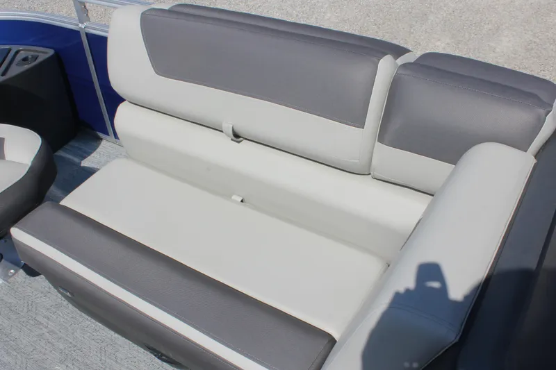 Slide: The Image of 2026 Sun Tracker Fishin' Barge 20 DLX boat seating, featuring gray and white upholstery. - 11
