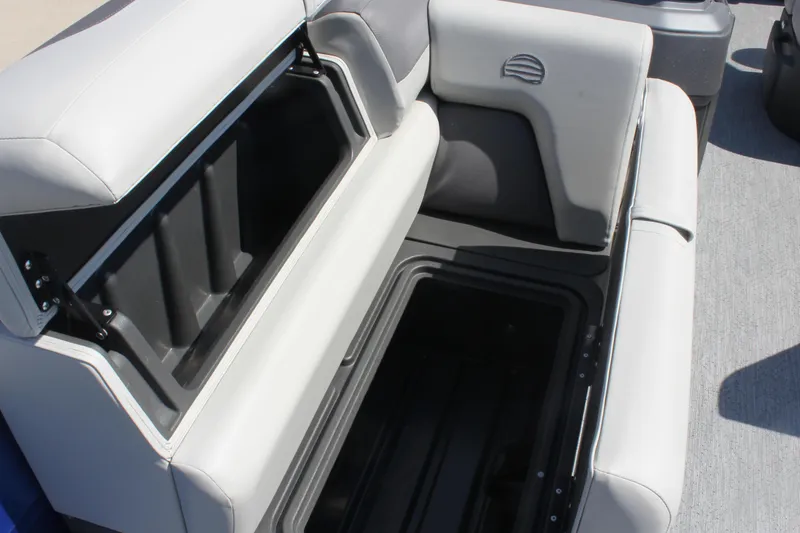 Slide: The Image of Sun Tracker Fishin' Barge 20 DLX 2026, open storage compartment, gray seating. - 12