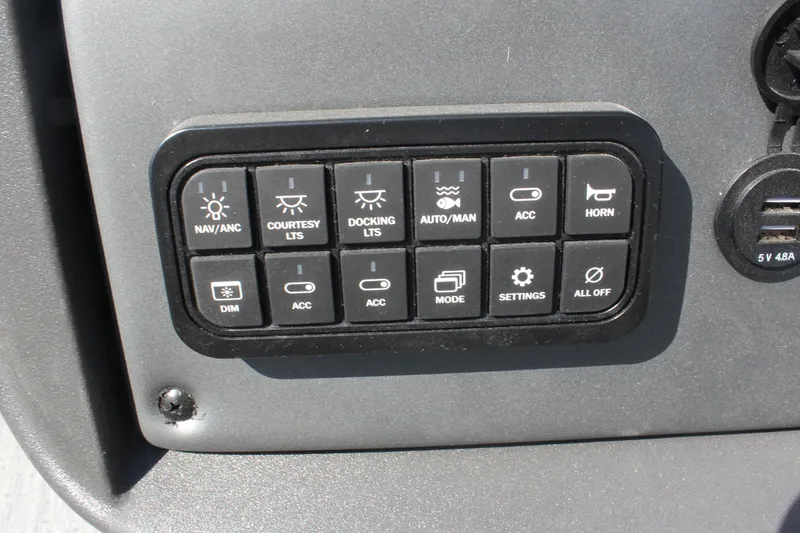 Slide: The Image of Control panel of 2026 Sun Tracker Fishin' Barge 20 DLX with various function buttons. - 17