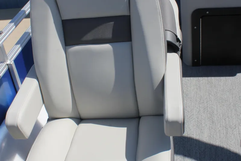 Slide: The Image of 2026 Sun Tracker Fishin' Barge 20 DLX boat seat, gray upholstery, armrests, and textured flooring. - 18