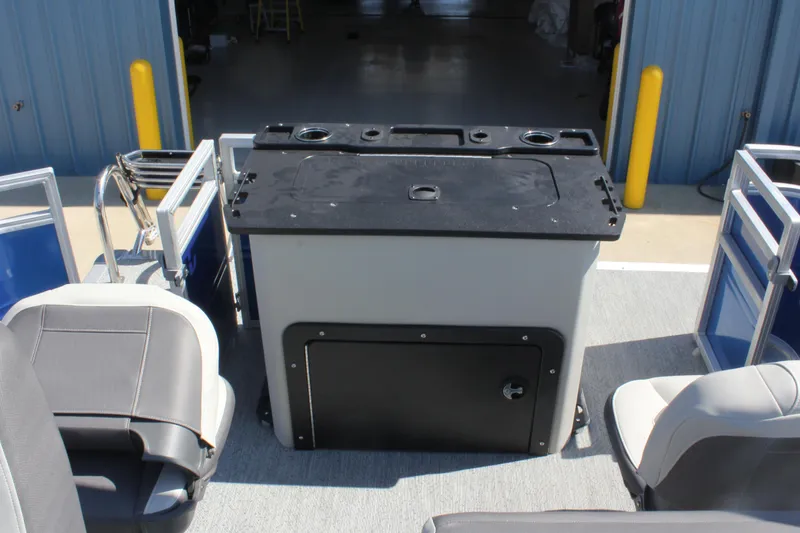 Slide: The Image of 2026 Sun Tracker Fishin' Barge 20 DLX interior with seating and storage. - 19