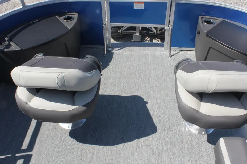Slide: The Image of 2026 Sun Tracker Fishin' Barge 20 DLX interior with swivel seats and cup holders. - 5