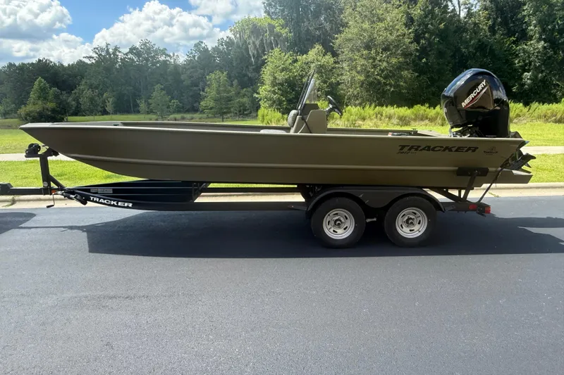The Image of 2026 Tracker Grizzly 2072 CC boat on trailer, parked outdoors on a sunny day. - 0