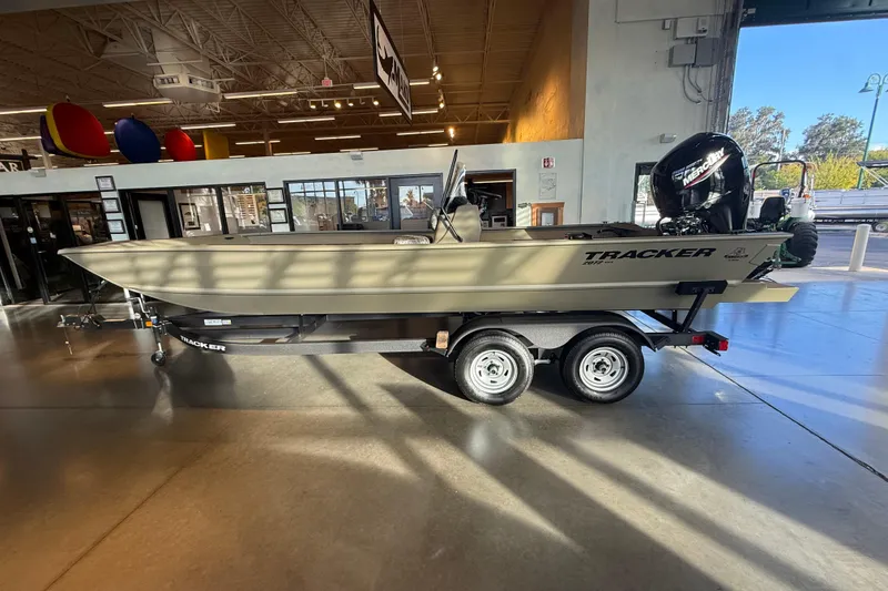 Slide: The Image of 2026 Tracker Grizzly 2072 CC boat on trailer in showroom, side view. - 4
