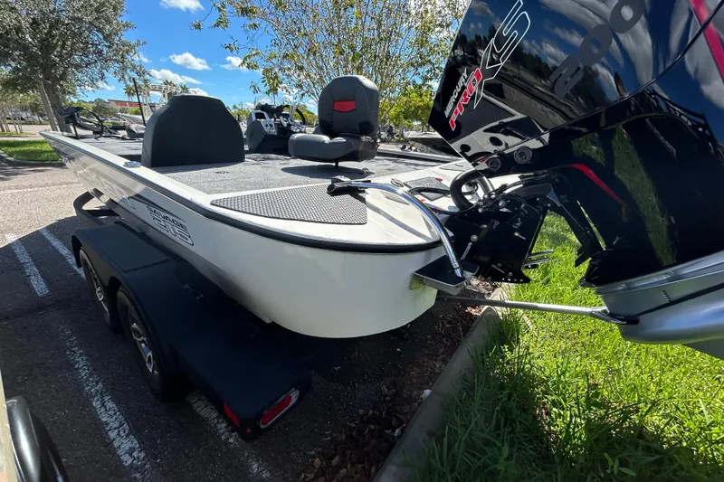 Slide: The Image of 2025 Tracker Savage 215 boat on trailer, featuring Mercury Pro XS engine, parked outdoors. - 3