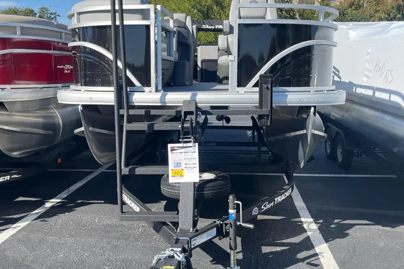 Slide: The Image of 2026 Sun Tracker SportFish 20 DLX pontoon boat on trailer in parking lot. - 68