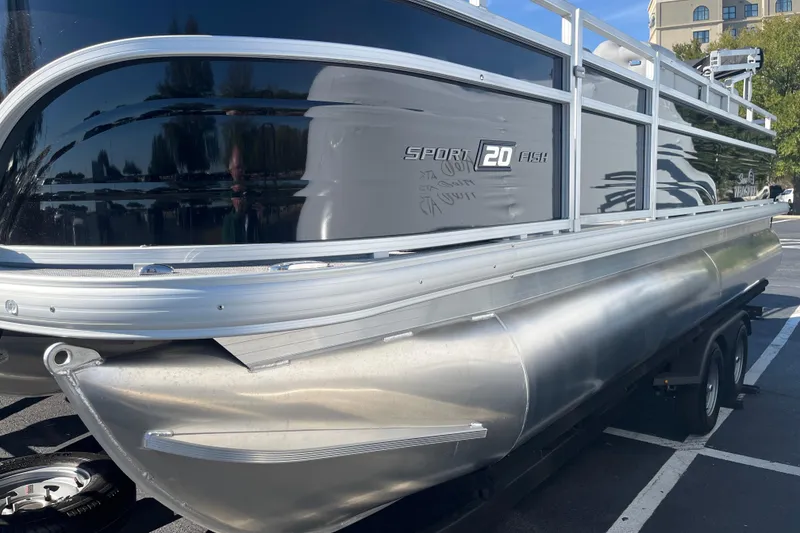 Slide: The Image of 2026 Sun Tracker SportFish 20 DLX pontoon boat on trailer in parking lot. - 69