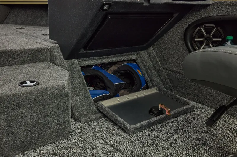 Slide: The Image of 2026 Tracker Targa V-19 Combo boat interior with storage compartment and speaker. - 27