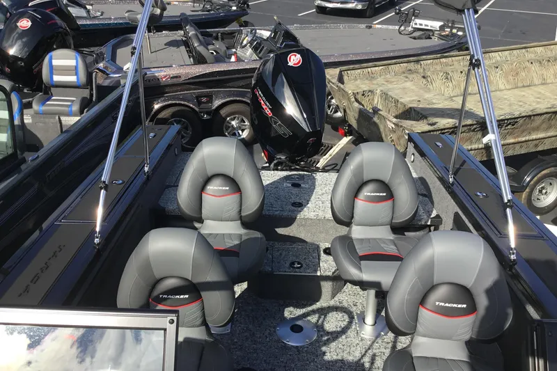 Slide: The Image of 2026 Tracker Targa V-19 Combo boat interior with four gray seats and motor. - 4