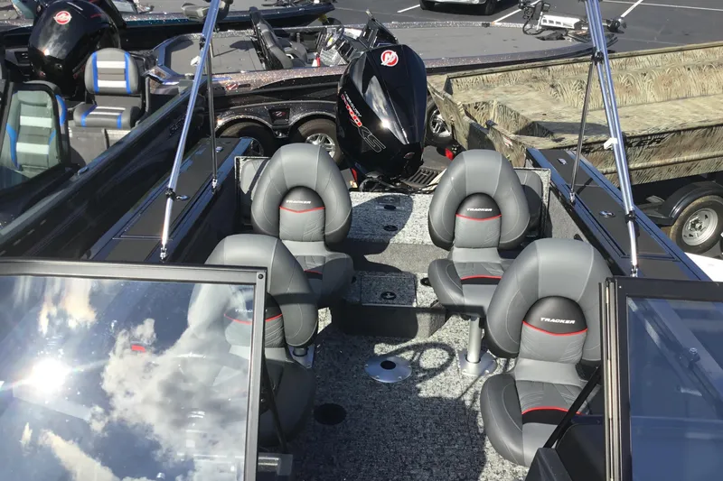 Slide: The Image of 2026 Tracker Targa V-19 Combo boat interior with four gray seats and a powerful outboard motor. - 5