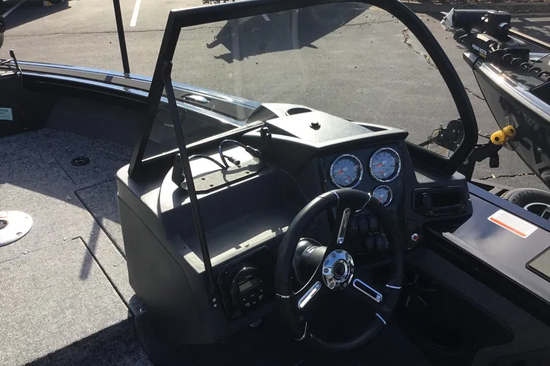 Slide: The Image of 2026 Tracker Targa V-19 Combo boat dashboard with steering wheel and gauges. - 6