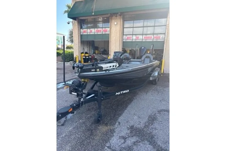 Slide: The Image of 2024 Nitro Z21 XL boat parked outside a garage, showcasing sleek design and modern features. - 3