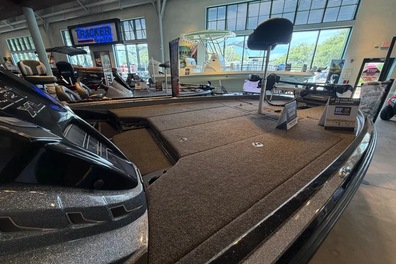 Slide: The Image of 2024 Nitro Z21 XL boat displayed in a showroom with promotional signage. - 1