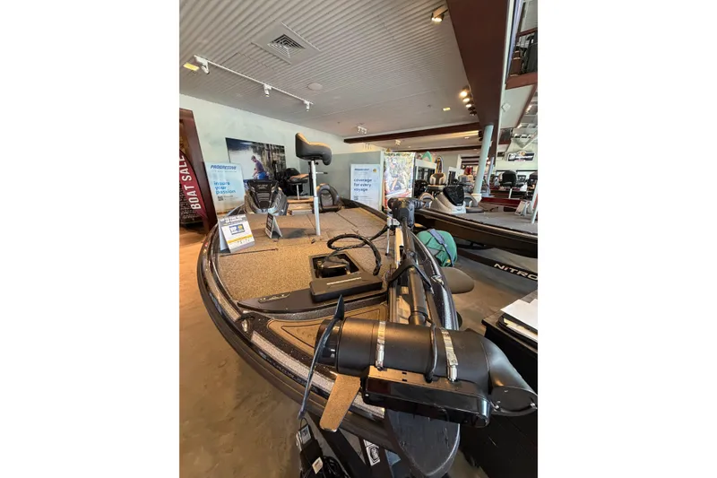 Slide: The Image of 2024 Nitro Z21 XL boat displayed in showroom with fishing equipment. - 3